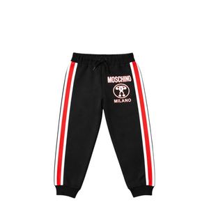 Black jogger pants with red stripes and Moschino logo on a white background